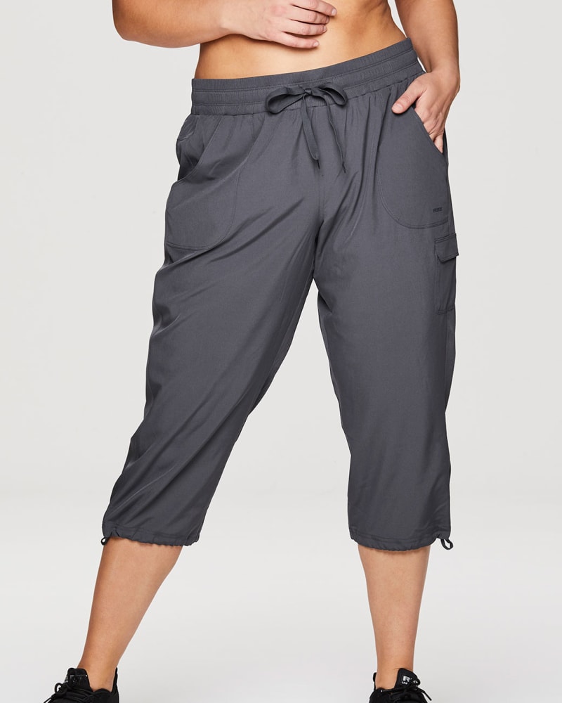 Front of a model wearing a size 1X Plus Prime Anywhere Cargo Capri in Charcoal by RBX Active. | dia_product_style_image_id:294448